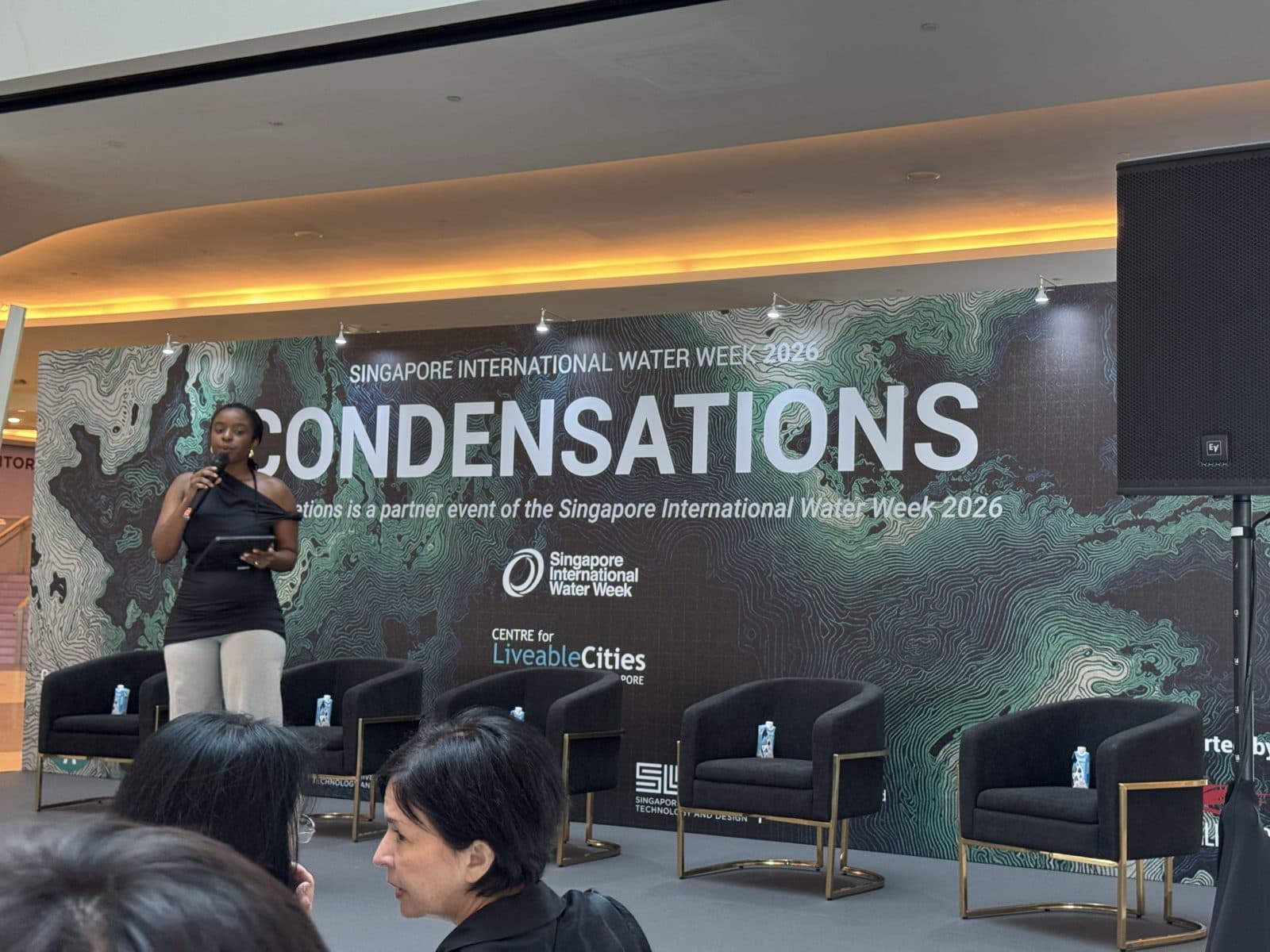 The Condensations 2026 symposium stage at SUTD, with the panel seated in front of the Condensations backdrop